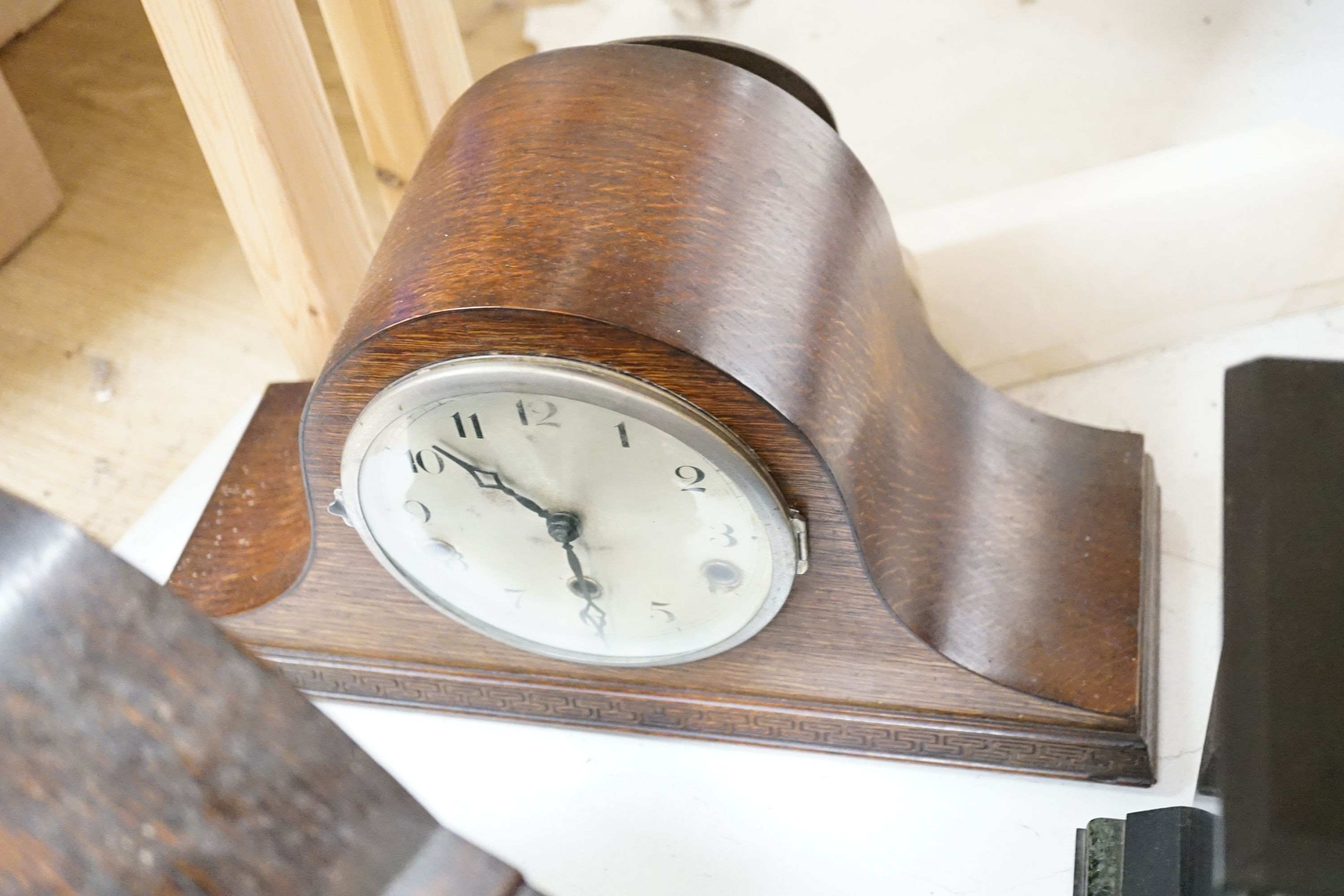 Two 19th century slate mantel clocks, three Edwardian and later wooden mantel clocks and a barometer, tallest 31 cms high.
